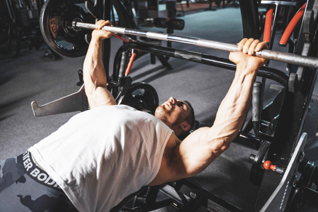 image of a man performing a bench press.
